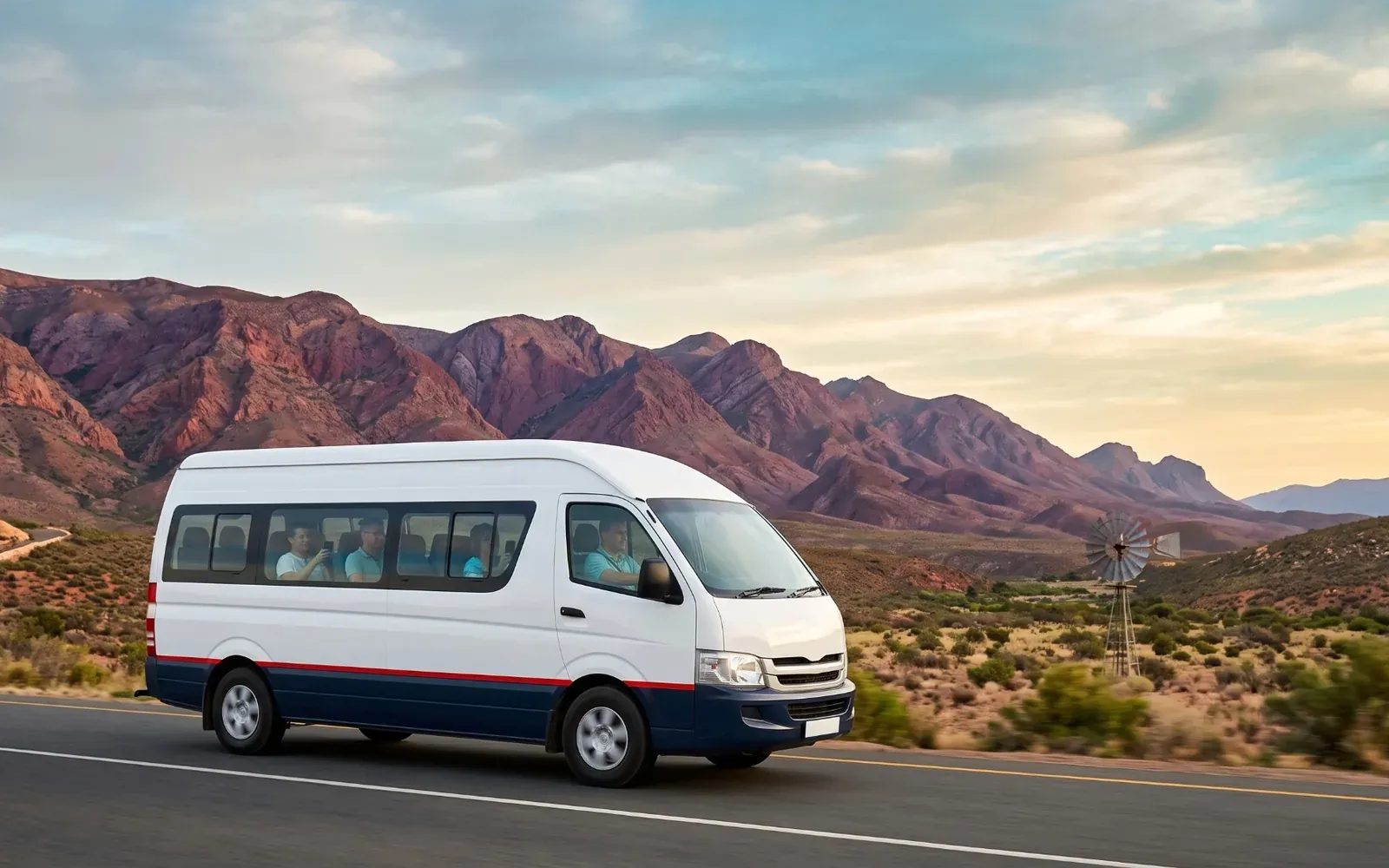 A tour minibus on Route 62 through the Klein Karoo, with mountain passes and big sky